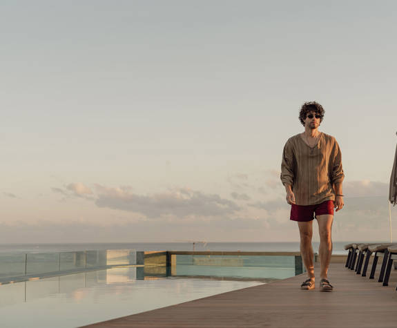 Man Walking beside the Pool 