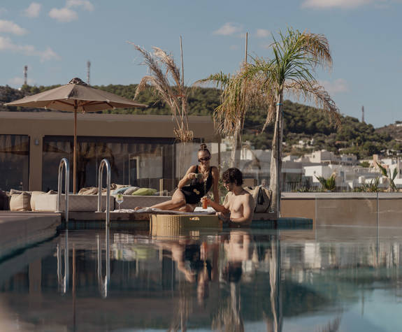 A Couple Enjoying their Meal At the Pool Side View