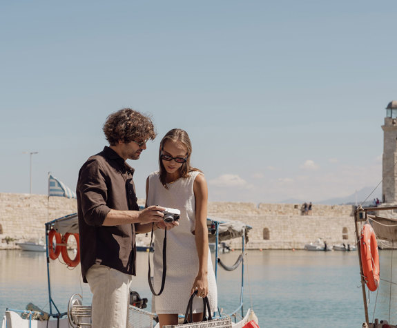Couple Watching The Photographs they Took in Their Downtown Walk 