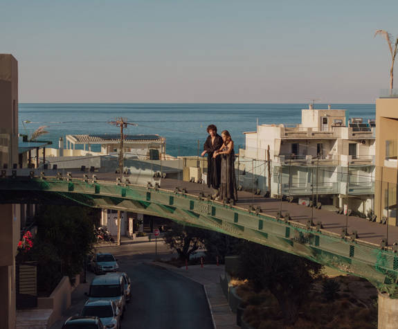 A Couple Standing on the Hotel Bridge Overlooking the City