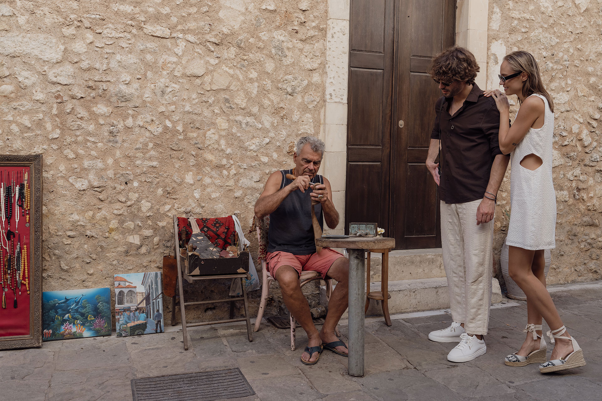 Couple Enjoying Watching A Traditional Instrument Maker Downtown