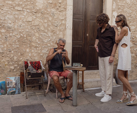 Couple Enjoying Watching A Traditional Instrument Maker Downtown