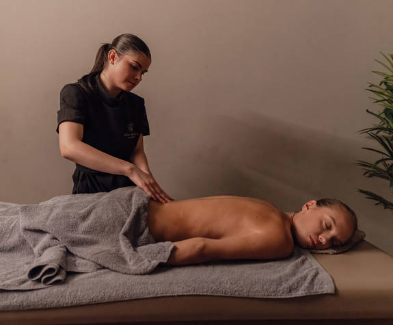 A Woman Enjoying a Relaxing Massage in the Massage Room