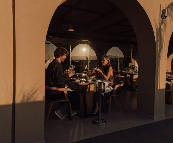 Minos Ambassador Elia Restaurant Couple Enjoying Their Wine as Sun Sets