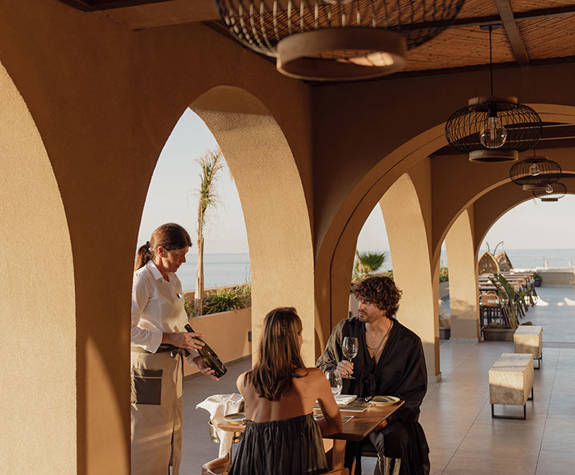 Minos Ambassador Elia Restaurant Waitress Recommends Wine to a Couple 