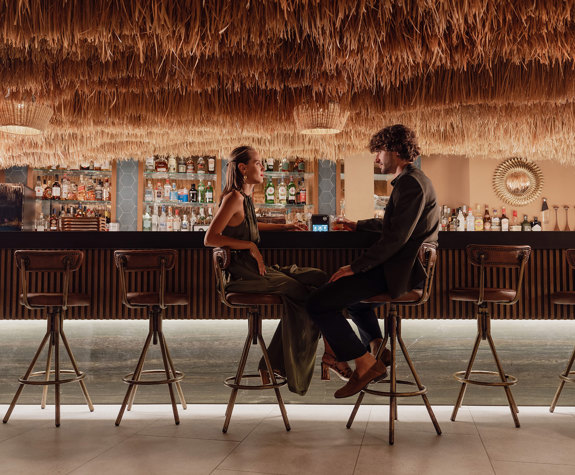 Minos Ambassador Thalassa Pool Bar Restaurant Couple enjoying their Drinks at the Bar