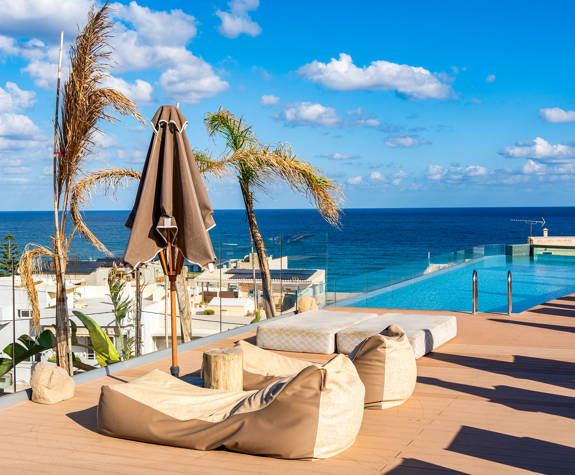 The Comfortable Mattresses Next to the Pool on the Rooftop