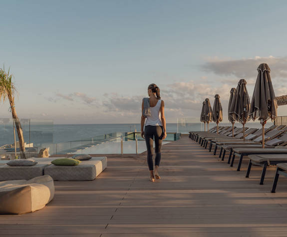 A Woman Walks towards the Pool Area