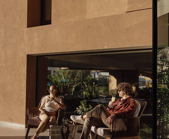 A Couple Enjoying a Drink in the Outdoor Area Of the Reception