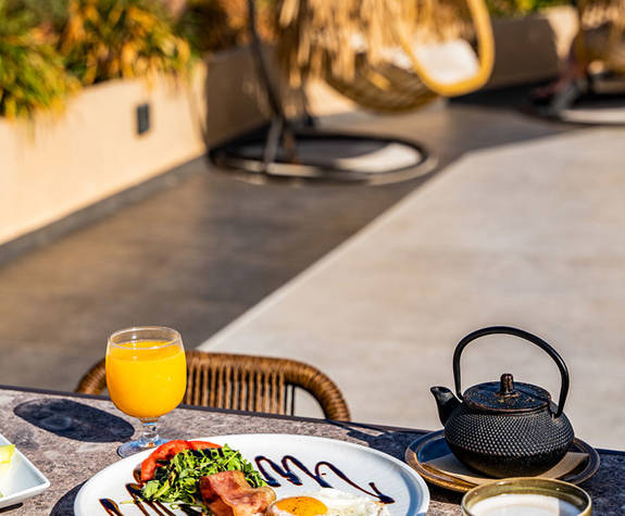Minos Ambassador Thalassa Pool Bar Table Outside Served with Fruits and English Breakfast