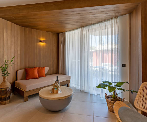 Minos Ambassador Junior Suite Bedroom Sofa and Balcony View