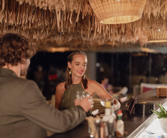 Minos Ambassador Thalassa Pool Bar Restaurant Couple enjoying their Drinks at the Bar