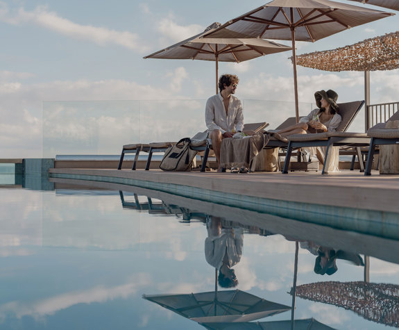 A Couple Relaxing with their Drinks on the Folding Chairs Wide View