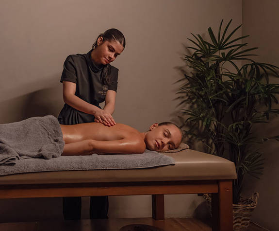 A Woman Enjoying a Relaxing Massage in the Massage Room
