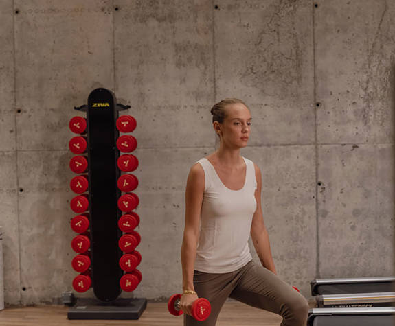 A Woman Exercises with Weights