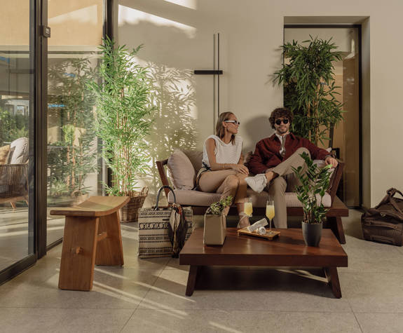 A Couple Enjoying A Drink While Waiting in the Comfortable Lounge of the Reception