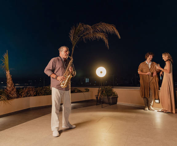 Couple Enjoying their drinks to the Sounds of Saxophone