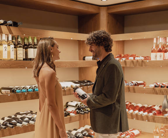 Minos Ambassador Wine Cellar Couple Choosing Their Wine From the Cellar