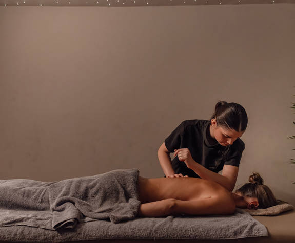A Woman Enjoying a Relaxing Massage in the Massage Room